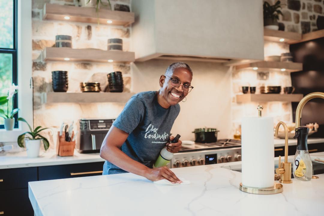 Household manager wiping a kitchen counter
